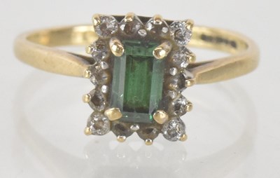 Lot 1298 - A 9ct yellow gold emerald and white stone set...