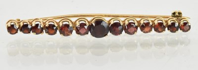 Lot 1535 - An 18ct yellow gold garnet set thirteen stone...