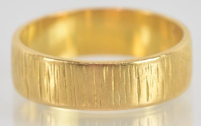 Lot 1334 - A yellow metal wedding band, size K, approx 4.2g.