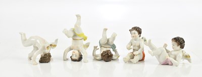 Lot 1591 - Five Continental porcelain models of cherubs,...