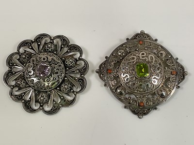 Lot 600 - Two Indian inspired large white metal brooches,...