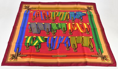 Lot 722 - HERMÈS; a red and multicoloured 100% silk...