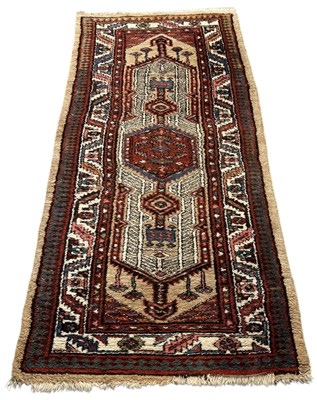 Lot 104 - A Persian red and cream ground rectangular...