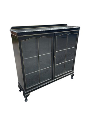 Lot 2191 - A 1920s ebonised two door display cabinet, on...