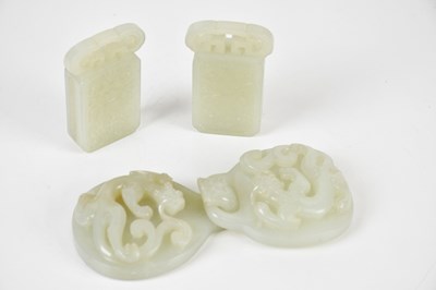 Lot 36 - A Chinese white jade four piece buckle set...