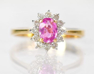 Lot 744 - An 18ct yellow gold ring set with an oval pink...