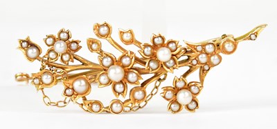 Lot 833 - A yellow metal floral brooch set with seed...
