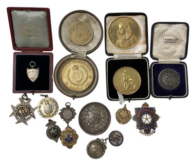 Lot 312 - A group of silver medals, badges and...