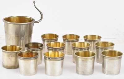 Lot 1118 - A set of twelve French white metal shot cups,...