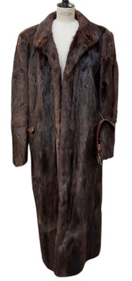 Lot 574 - A long lady's musquash fur coat.
