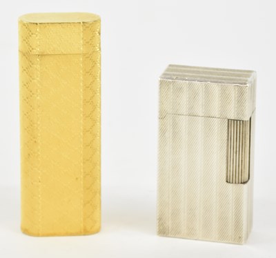Lot 313 - CARTIER; a gold plated cigarette lighter,...