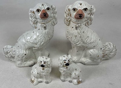 Lot 203 - A pair of Staffordshire style spaniels, height...