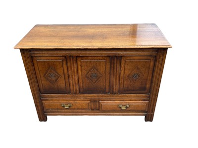 Lot 2101 - A reproduction carved and panelled oak coffer,...