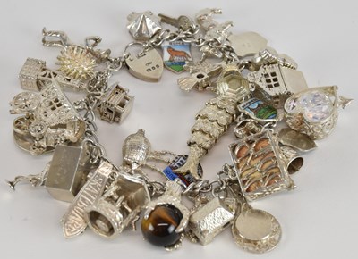 Lot 1120 - A modern hallmarked silver charm bracelet,...