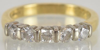 Lot 1235 - An 18ct yellow gold diamond five stone ring,...