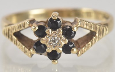 Lot 1368 - A 9ct gold diamond and sapphire set dress ring,...