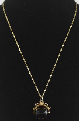Lot 1462 - A smoky quartz swivel fob in a 9ct gold mount,...