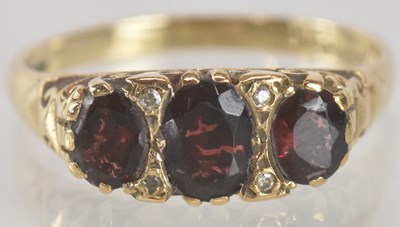 Lot 1338 - A 9ct gold dress ring, set with three...