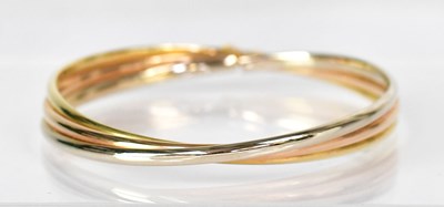 Lot 807 - An 18ct yellow gold three-band bangle, stamped...