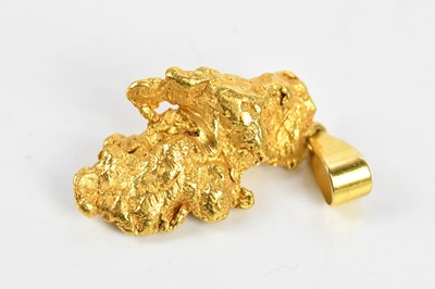 Lot 316 - A yellow metal nugget with suspended bail,...
