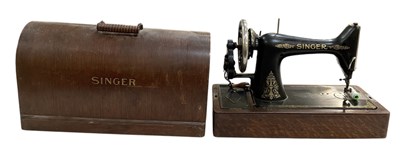 Lot 359 - An early 20th century oak cased Singer sewing...