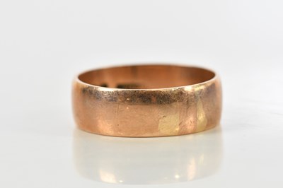 Lot 190 - A broad 9ct rose gold wedding band, size W,...