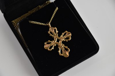 Lot 381 - A 9ct yellow gold pierced cross pendant on...