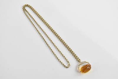 Lot 360 - A 9ct yellow gold chain supporting a 9ct...