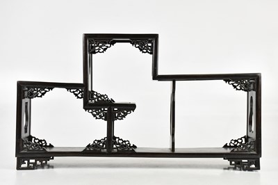 Lot 84 - A modern Chinese carved hard wood display stand.