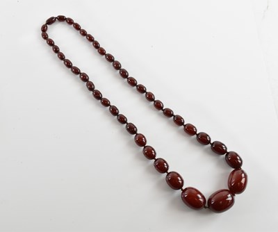Lot 359 - A large vintage hand tied cherry amber...
