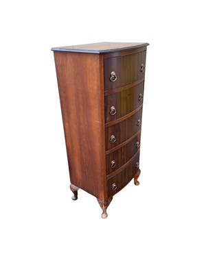 Lot 2187 - A 1950s bowfront chest of five drawers, on pad...