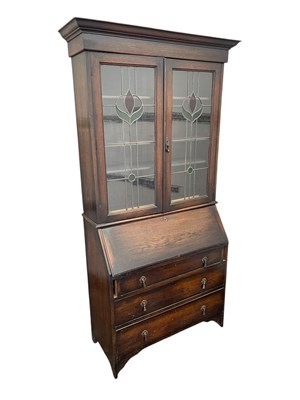 Lot 2169 - A 1920s oak bureau bookcase, with two lead...