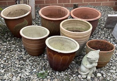 Lot 673 - Seven various garden pots and a cat figure,...