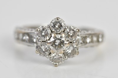 Lot 50 - An 18ct white gold diamond daisy ring with...