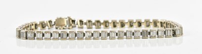 Lot 15 - A white metal diamond set tennis bracelet,...