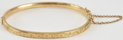 Lot 1613 - A 9ct gold hinged bracelet, with floral...