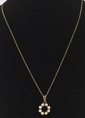 Lot 1467 - A 9ct gold circular seed pearl open pendant,...