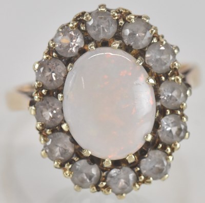 Lot 1359 - A 9ct gold dress ring, with oval white opal to...