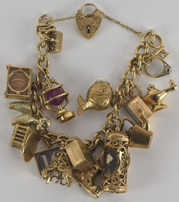 Lot 1568 - A 9ct gold charm bracelet with sixteen charms,...