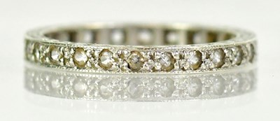 Lot 779 - A 9ct white gold eternity ring set with white...