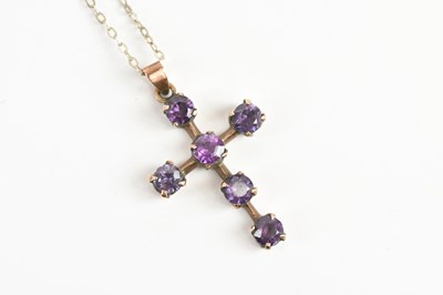Lot 1629 - A yellow metal cross set with six amethyst...