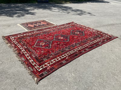 Lot 2325 - A large hand knotted Persian red ground...
