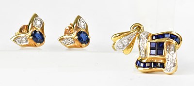 Lot 909 - An 18ct yellow gold pendant set with sapphires...