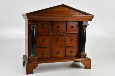 Lot 1294 - A mahogany miniature chest of nine drawers,...