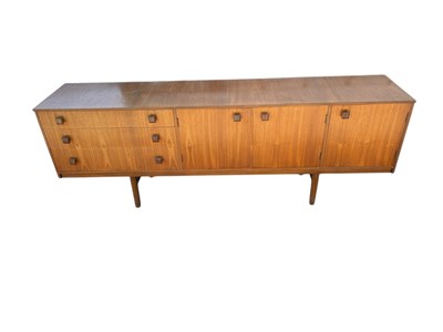 Lot 2281 - A mid century teak sideboard, with three...