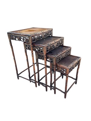 Lot 2124 - A Chinese carved hardwood nest of four tables,...