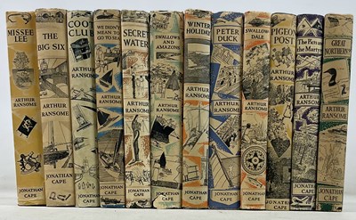 Lot 377 - ARTHUR RANSOME; a collection of twelve books...