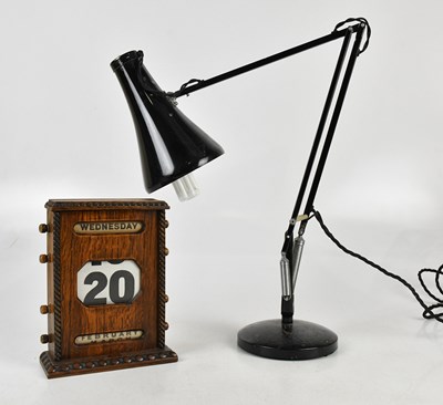 Lot 1295 - An early 20th century oak desk calendar,...