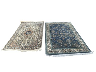 Lot 2326 - A beige ground Persian style rug with floral...