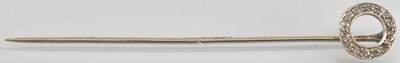 Lot 1542 - A white metal diamond set stick pin, the...